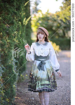 A beautiful woman in lolita dress in garden background Japanese street fashion portrait A beautiful woman in lolita dress in garden background Japanese street fashion portrait 96077800