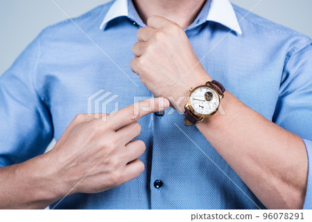 Value your time. Manager cropped view point finger at wrist watch. Time management. Meeting deadline. Punctuality and promptness. Business appointment. Fashion accessory Value your time. Manager cropped view point finger at wrist watch. Time management. Meeting deadline. Punctuality and promptness. Business appointment. Fashion accessory 96078291
