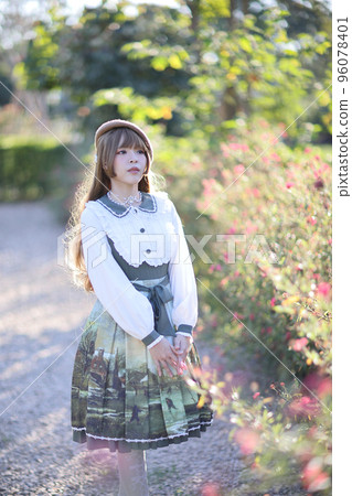 A beautiful woman in lolita dress in garden background Japanese street fashion portrait A beautiful woman in lolita dress in garden background Japanese street fashion portrait 96078401