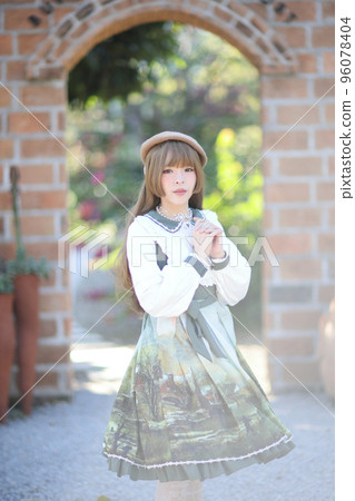 A beautiful woman in lolita dress in garden background Japanese street fashion portrait A beautiful woman in lolita dress in garden background Japanese street fashion portrait 96078404