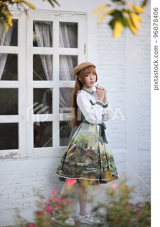 A beautiful woman in lolita dress in garden background Japanese street fashion portrait A beautiful woman in lolita dress in garden background Japanese street fashion portrait 96078406