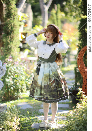 A beautiful woman in lolita dress in garden background Japanese street fashion portrait A beautiful woman in lolita dress in garden background Japanese street fashion portrait 96078407