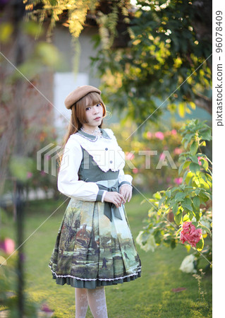 A beautiful woman in lolita dress in garden background Japanese street fashion portrait A beautiful woman in lolita dress in garden background Japanese street fashion portrait 96078409