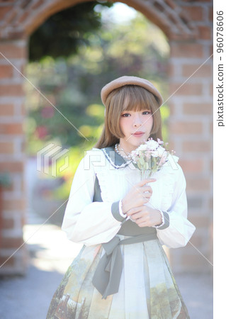 A beautiful woman in lolita dress in garden background Japanese street fashion portrait A beautiful woman in lolita dress in garden background Japanese street fashion portrait 96078606