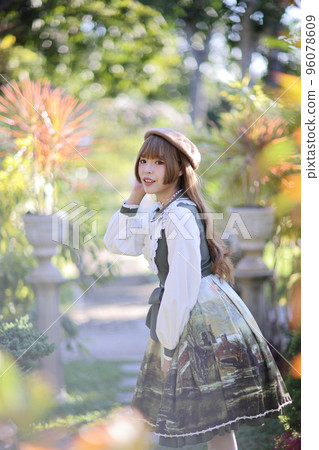 A beautiful woman in lolita dress in garden background Japanese street fashion portrait A beautiful woman in lolita dress in garden background Japanese street fashion portrait 96078609