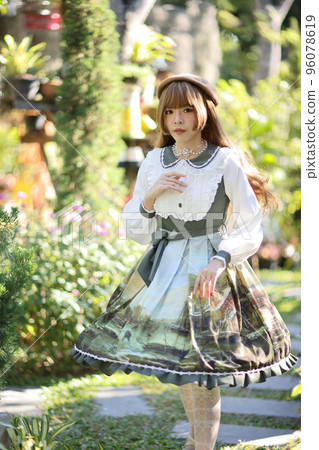 A beautiful woman in lolita dress in garden background Japanese street fashion portrait A beautiful woman in lolita dress in garden background Japanese street fashion portrait 96078619