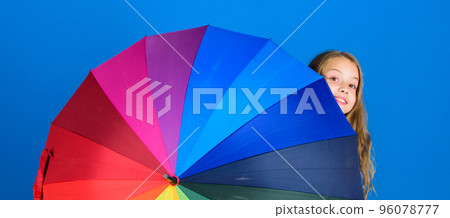 Colorful umbrella accessory. Weather forecast concept. Stay positive though rainy day. Brighten up life. Kid peek out colorful rainbow umbrella. Color your life. Girl cheerful hide behind umbrella 96078777