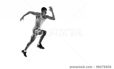 Black and white portrait of muscular male athlete, runner, jogger in motion isolated on white background. Monochrome. Sport, beauty, power and style Black and white portrait of muscular male athlete, runner, jogger in motion isolated on white background. Monochrome. Sport, beauty, power and style 96078808