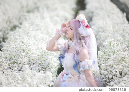 Portrait of Asian young woman with lolita fashion dress in white flower garden background 96078816