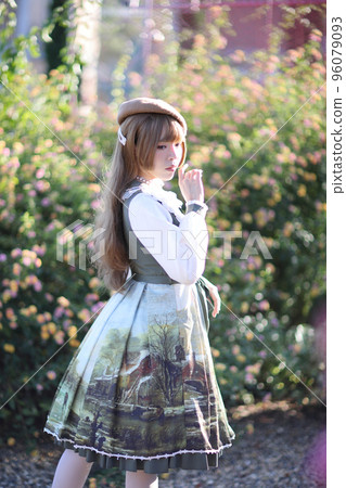 A beautiful woman in lolita dress in garden background Japanese street fashion portrait 96079093