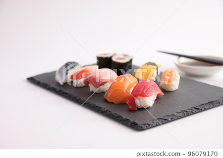 Sushi Set nigiri and sushi rolls with soy sauce and chopsticks Japanese food isolated in white background Sushi Set nigiri and sushi rolls with soy sauce and chopsticks Japanese food isolated in white background 96079170
