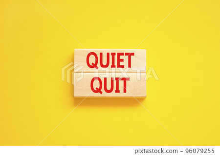 Quiet quit symbol. Concept words Quiet quit on wooden blocks. Beautiful yellow table yellow background. Business and quiet quit concept. Copy space. 96079255