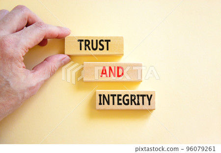 Trust and integrity symbol. Concept words Trust and integrity on wooden blocks. Businessman hand. Beautiful white background. Business, psychological and trust and integrity concept. Copy space. 96079261