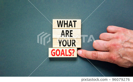 What are your goals symbol. Concept words What are your goals on wooden blocks. Beautiful grey table grey background. Businessman hand. Business psychological what are your goals concept. Copy space What are your goals symbol. Concept words What are your goals on wooden blocks. Beautiful grey table grey background. Businessman hand. Business psychological what are your goals concept. Copy space 96079276