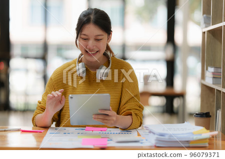 Attractive female student learning language, watching online webinar, listening audio course, e-learning education concept Attractive female student learning language, watching online webinar, listening audio course, e-learning education concept 96079371