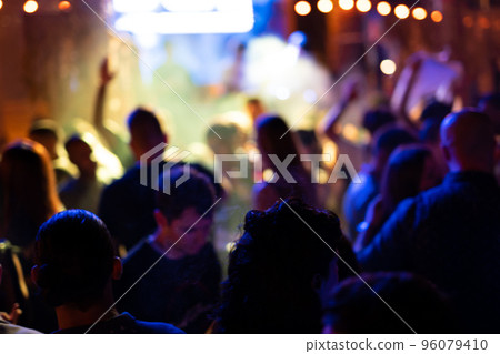 Blurred photo of people at a night disco. Blurred photo of people at a night disco. 96079410