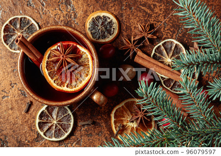 Hot Christmas drink with spices, dried citrus, and cranberries. Hot Christmas drink with spices, dried citrus, and cranberries. 96079597