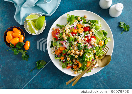 Tabbouleh salad. Tabouli salad with fresh parsley, onions, tomatoes, bulgur and chickpea. Healthy vegetarian food, diet. Top view Tabbouleh salad. Tabouli salad with fresh parsley, onions, tomatoes, bulgur and chickpea. Healthy vegetarian food, diet. Top view 96079708