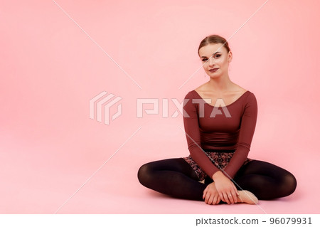 Graceful ballerina sitting in studio 96079931