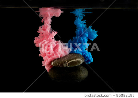 Blue and pink acrylic colors ink in water on black background. A podium made of natural stone for your design of the layout of a cosmetic product or jewelry.  96082195