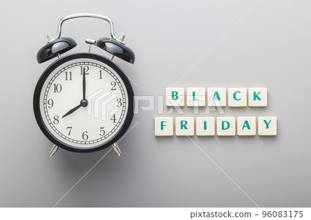 Black friday text and alarm clock on gray background. Top view. Black friday text and alarm clock on gray background. Top view. 96083175
