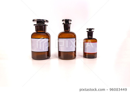 Three medical jars with glass stoppers on a white background Three medical jars with glass stoppers on a white background 96083449