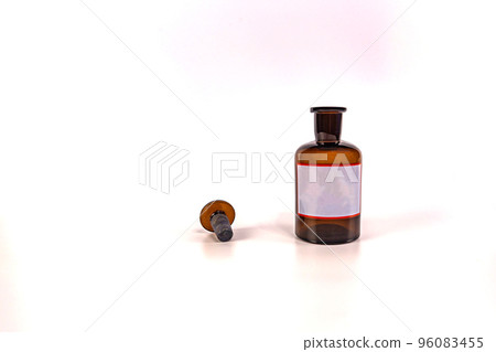 Brown medical jar with a glass stopper on a white background with a label Brown medical jar with a glass stopper on a white background with a label 96083455