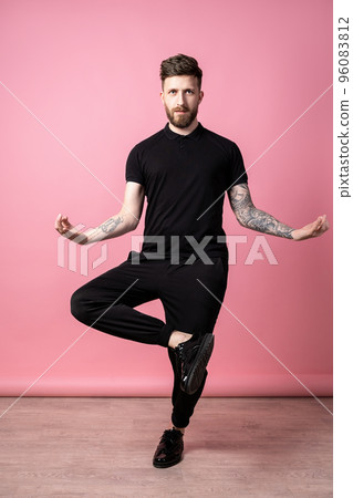 Full length of funny, crazy, emotional, handsome guy who wearing in total black depicts meditation Full length of funny, crazy, emotional, handsome guy who wearing in total black depicts meditation 96083812
