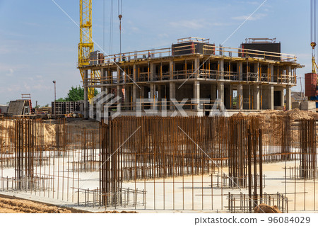Crane and building construction site against blue sky. Crane and building construction site against blue sky. 96084029