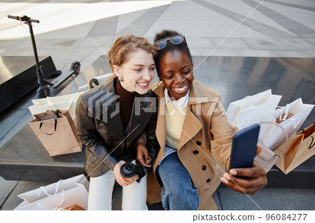 Two Girls Taking Selfie Photo Outside Shopping Mall Two Girls Taking Selfie Photo Outside Shopping Mall 96084277