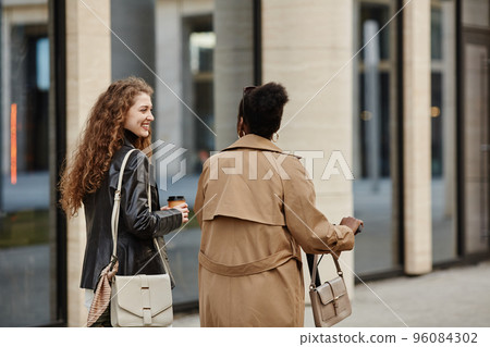 Two Girlfriends Walking in City Two Girlfriends Walking in City 96084302