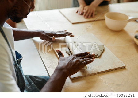Male hands shaping clay Male hands shaping clay 96085281