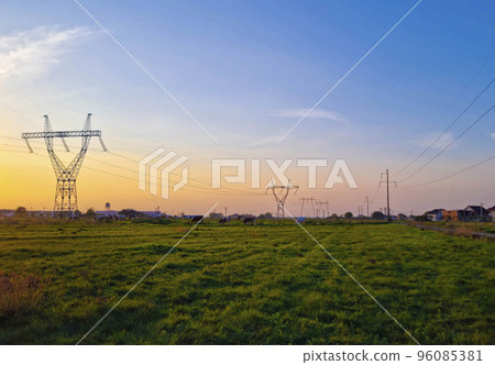 High voltage electric poles, rural landscape with power pylons in a row, at sunset High voltage electric poles, rural landscape with power pylons in a row, at sunset 96085381