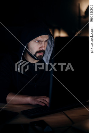 Man using pc for cyber crime Man using pc for cyber crime 96086302