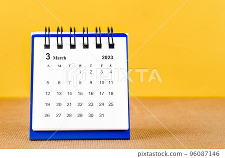 The March 2023 Monthly desk calendar for 2023 on yellow background. 96087146