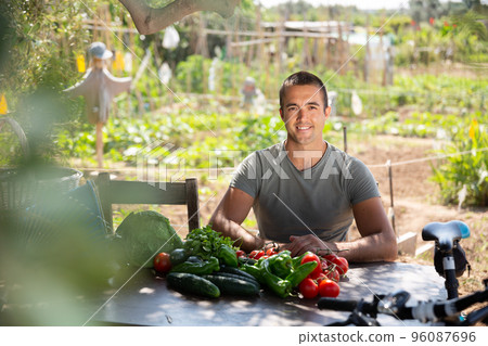 Young man gardener resting after harvesting of vegetables 96087696