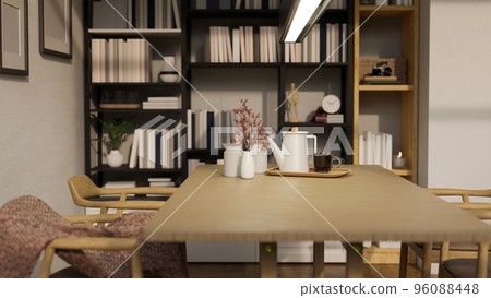 Modern home dining room with minimal wood dining table and bookshelves in background Modern home dining room with minimal wood dining table and bookshelves in background 96088448