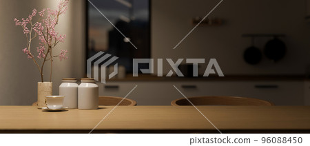 Modern wood dining table with copy space over blurred dark kitchen in background. Modern wood dining table with copy space over blurred dark kitchen in background. 96088450