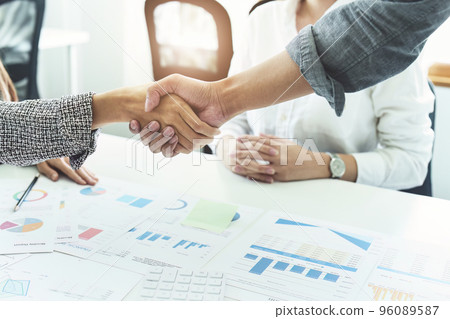 business merger, Asian businessmen shake hands at the conference room with showcase their collaboration to strengthen their marketing efforts. business merger, Asian businessmen shake hands at the conference room with showcase their collaboration to strengthen their marketing efforts. 96089587