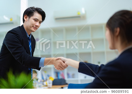 Asian entrepreneurs handshakes to congratulate the agreement between the two companies to enhance investment and financial strength. deal concept. 96089591