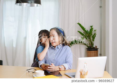 Asian portrait, grandmother and granddaughter doing leisure with little children whispering secrets between each other. 96089627