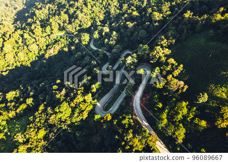 traveling on winding mountain road,Aerial View Of Winding Road Amidst Trees 96089667