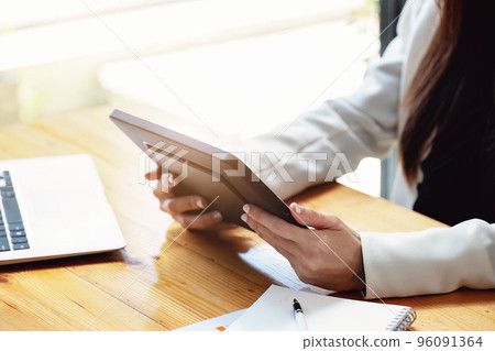 business woman using a tablet computer for data analysis, marketing, accounting. 96091364