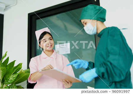 Portrait of doctor and nurse talking to prepare before going to the emergency room to treat patients. Portrait of doctor and nurse talking to prepare before going to the emergency room to treat patients. 96091997