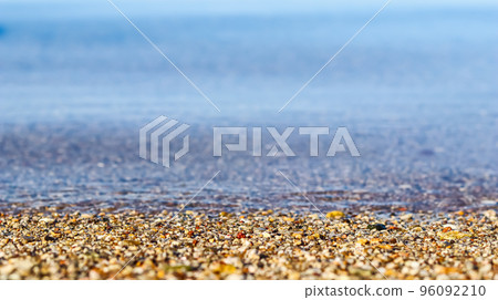 A background of sand, small pebbles and flowing wave on the sea beach. Summer vacation and coastal nature concept 96092210