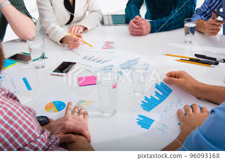 Team of business person works together on company statistics. Concept of teamwork Team of business person works together on company statistics. Concept of teamwork 96093168