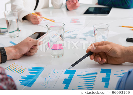 Team of business person works together on company statistics. Concept of teamwork Team of business person works together on company statistics. Concept of teamwork 96093169