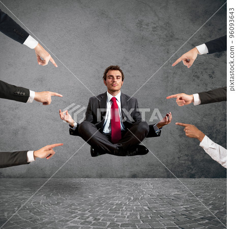 Relaxed businessman under the accusations of colleagues 96093643