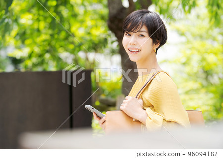 Short hair woman green background 96094182