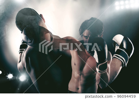 Boxer in a boxe competition beats his opponent Boxer in a boxe competition beats his opponent 96094459